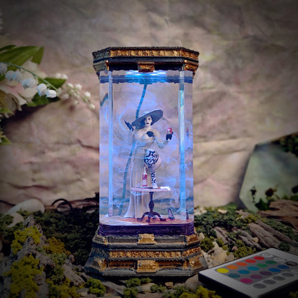 Decorative lamp with a figurine inside, surrounded by flowers and a blurred background