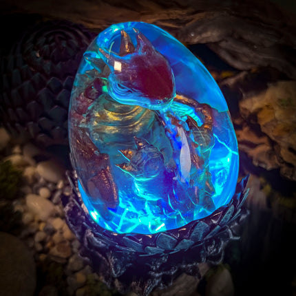Side view of the Forest Dragon Egg lamp showcasing professional resin clarity and detail.