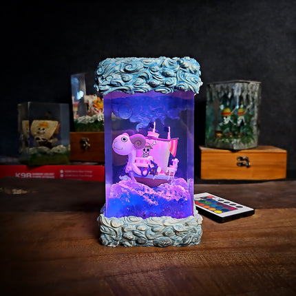 Decorative lamp with a pirate ship design on a wooden surface