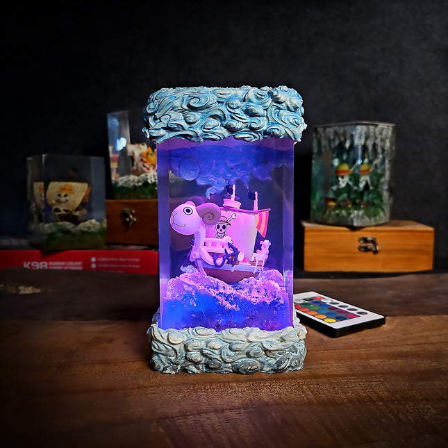 Decorative lamp with a pirate ship design on a wooden surface