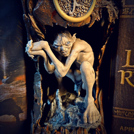 Close-up of LOTR Gollum bookshelf insert with atmospheric cave lighting effects.