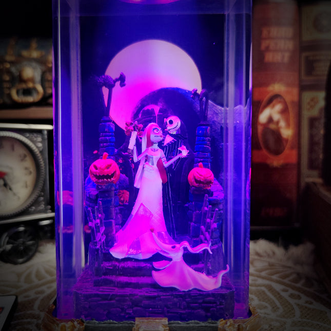 Decorative display case with animated characters under purple lighting