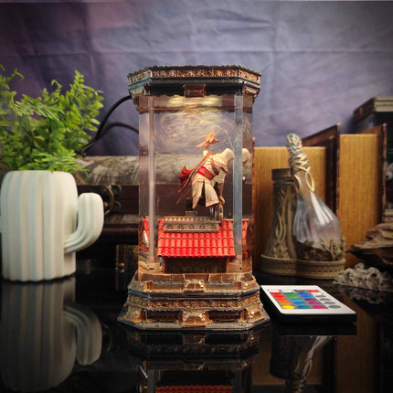 Decorative glass lantern with figurine on a table with a plant and books in the background