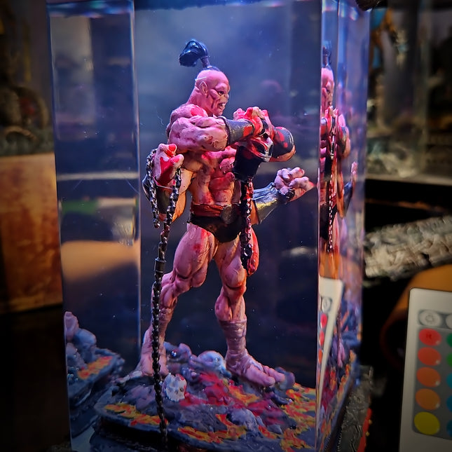 Muscular action figure in a display case with colorful base