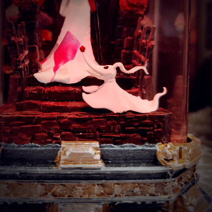 Decorative cake with a figurine of a woman in a pink dress on a staircase