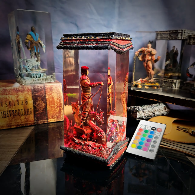 Decorative figure in a glass case with a remote control on a table.