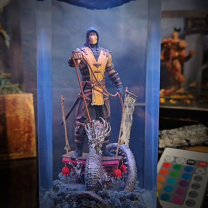 Action figure of a warrior with a dragon on a platform, surrounded by a blue light box.