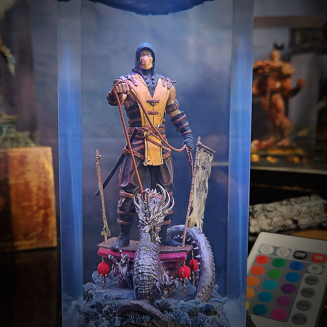 Action figure of a warrior with a dragon on a platform, surrounded by a blue light box.