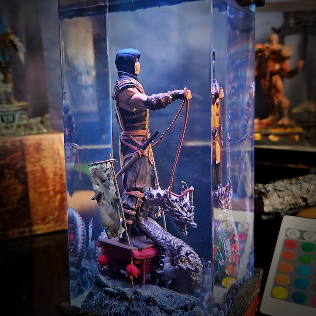 Figurine of a warrior with a dragon in a display case, surrounded by other figurines.