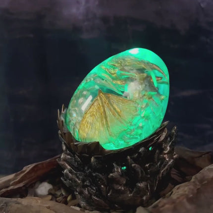 Luxury epoxy resin dragon egg featuring a hatching fire dragon for fantasy decor.